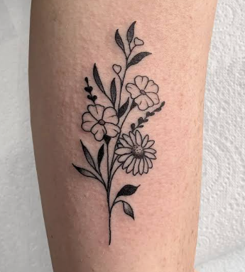 Fine line floral tattoo reference with a small wildflower bouquet on an arm